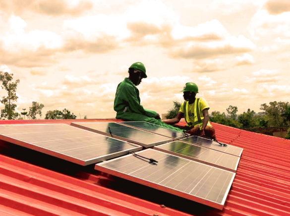Village Energy installing a solar panel in Uganda
