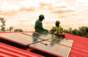 Village Energy's technicians installing solar panels in Uganda